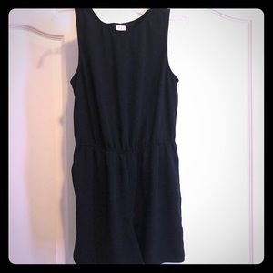 Adorable black romper with cross cross back.